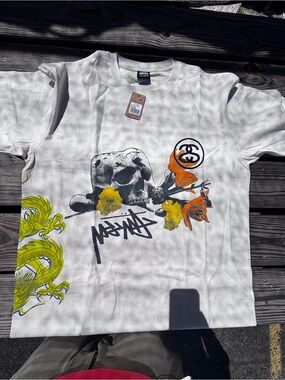 Stussy White Graphic Skull Tee with Orange & Yellow Accents